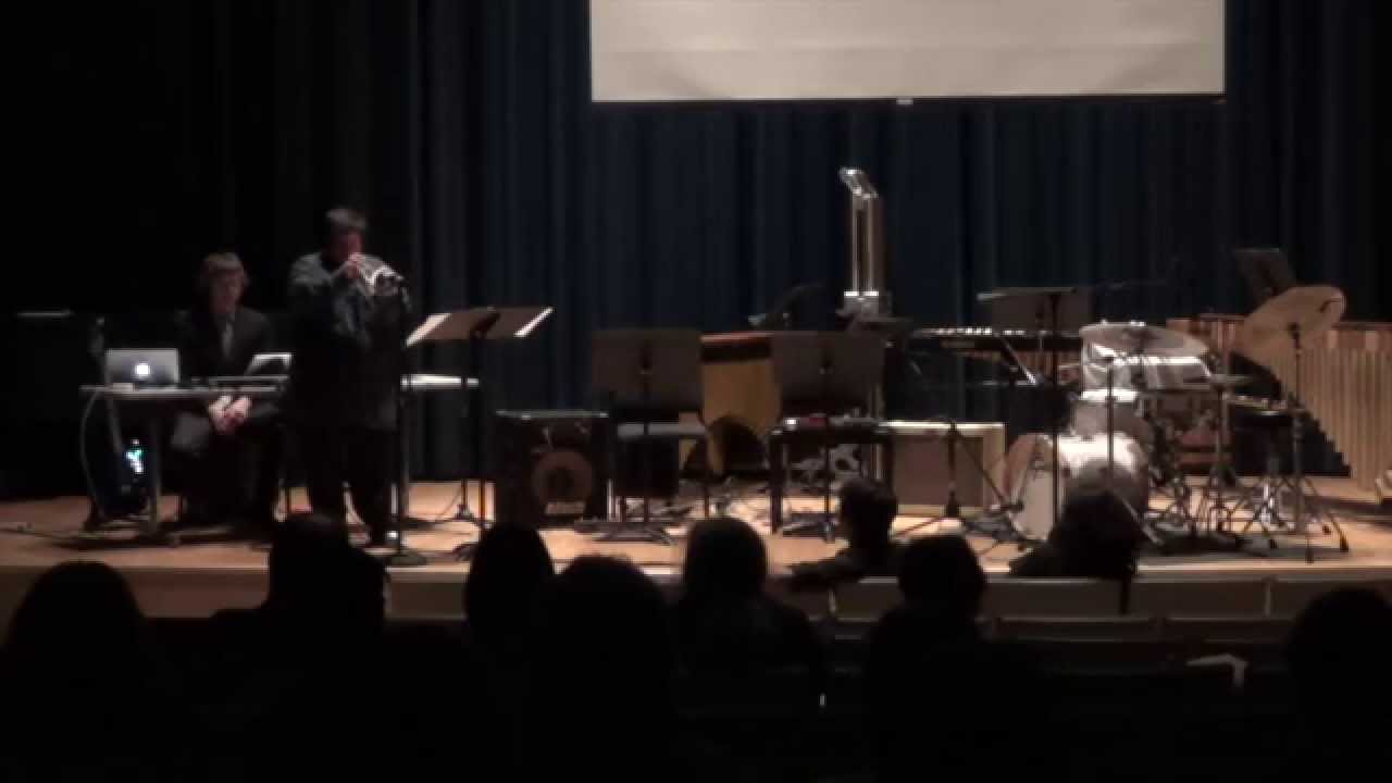Alec Trumble performing Highway Circuits with trumpet and computer on a recital stage